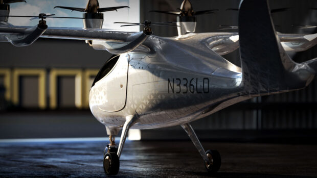 white EVTOL leaving an airplane hangar