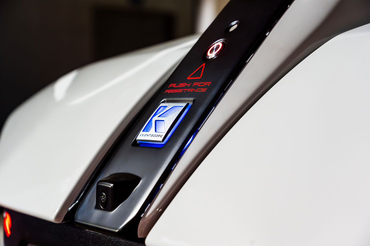 Close up Knightscope logo and "push for assistance" button at rear of vehicle
